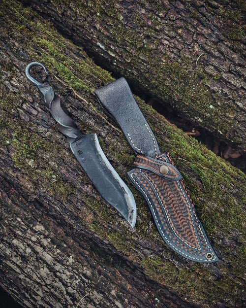 Blacksmith hand forged primitive style custom carbon steel knife with leather sheath