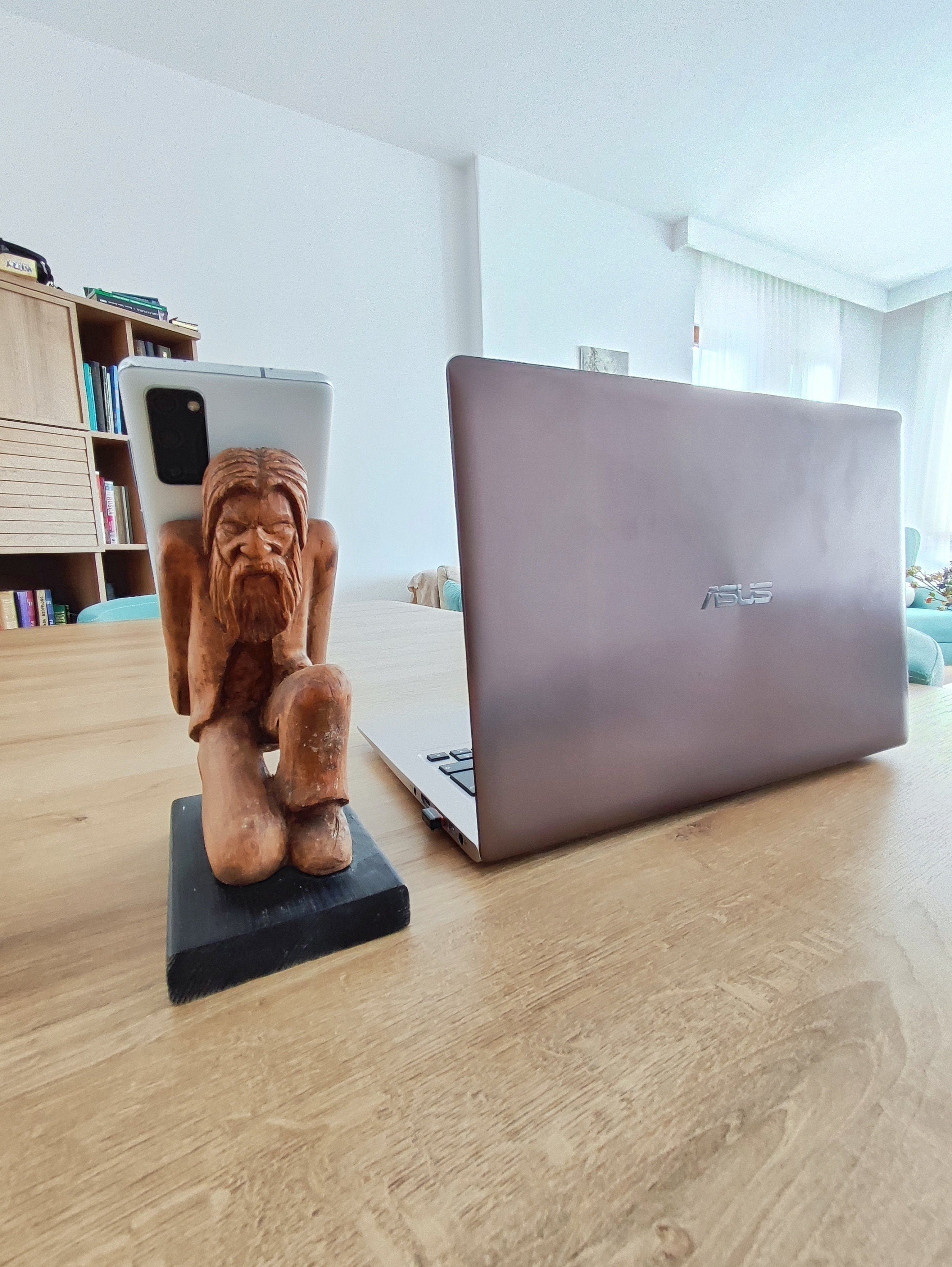 The Burden on Technology's Shoulders: Wooden Elder and Smartphone Stand